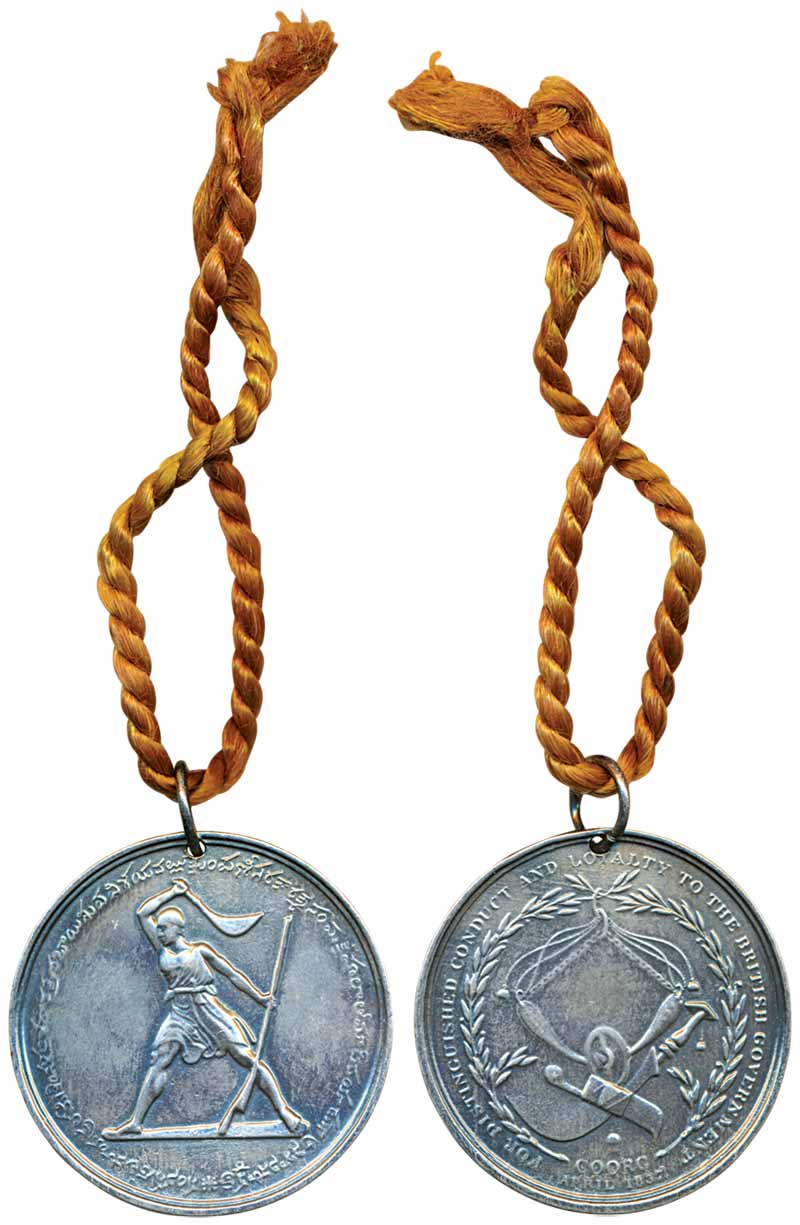 Coorg Medal, a soldier wielding a weapon to left and circular legend around on obv, wreath